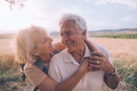 A wife and a husband in their late adult ages hugging each other