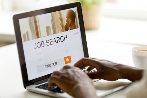 African-american man browsing work online using online job search application