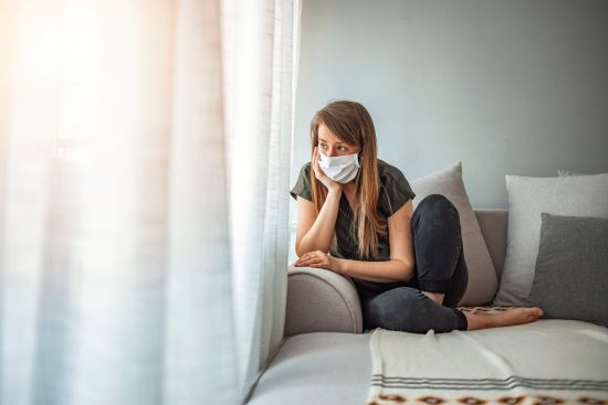 Woman in isolation at home for virus outbreak. Young woman in isolation at home for coronavirus. Woman in Isolation Quarantine Coronavirus. Sad lonely girl isolated stay at home