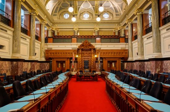 An image of the throne and desks inside the British Columbia legislature.