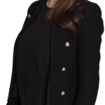 Photo of Eckler Principal Eva Helgerson-Imbeault. She is wearing a black jacket and pants, and is looking straight into the camera smiling.