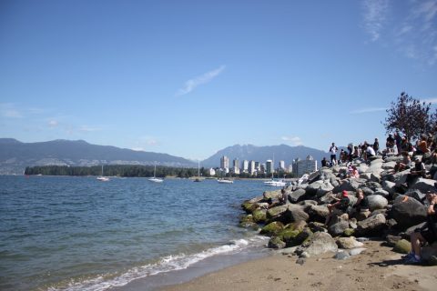 Guests watching canoe landing at Ambleside in West Vancouver - stock photo July 14, 2017. Canada. Vancouver. Vanier Park. Gathering of Canoes, one of the signature events of Canada 150 celebration. During 10-day journey about 30 canoes with First Nations, Public Service Agencies and youth paddlers travel from the Sunshine Coast to the City of Vancouver and request permission to land on the traditional territories of the Musqueam, Squamish and Tsleil-Waututh First Nations.