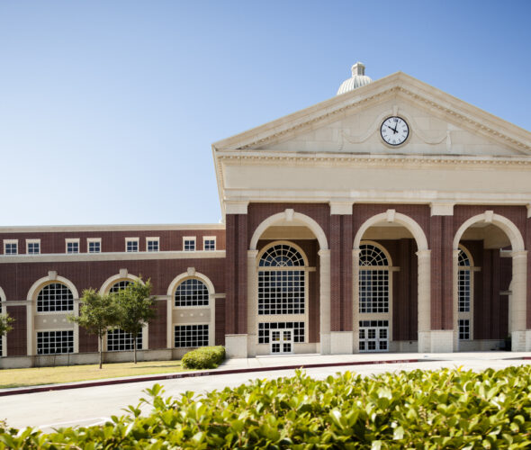 Education: College or high school campus entrance. Building. Front entrance to a highschool.